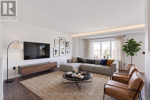 A living room with a couch, chairs, and a television.