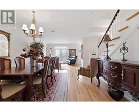 A dining room with a wooden table and chairs.