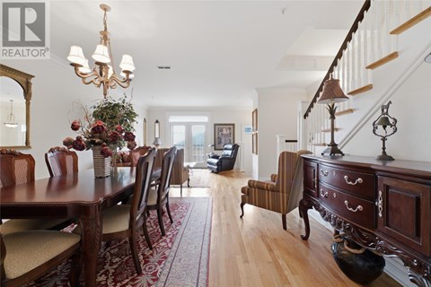 A dining room with a wooden table and chairs.