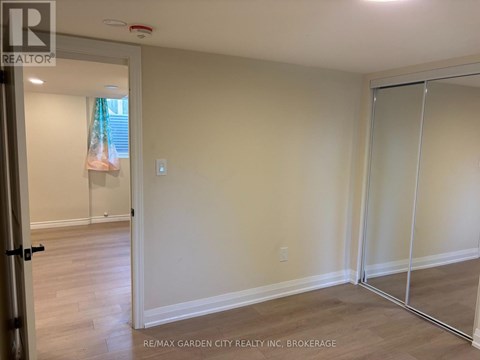 A room with a sliding glass door and a wooden floor.