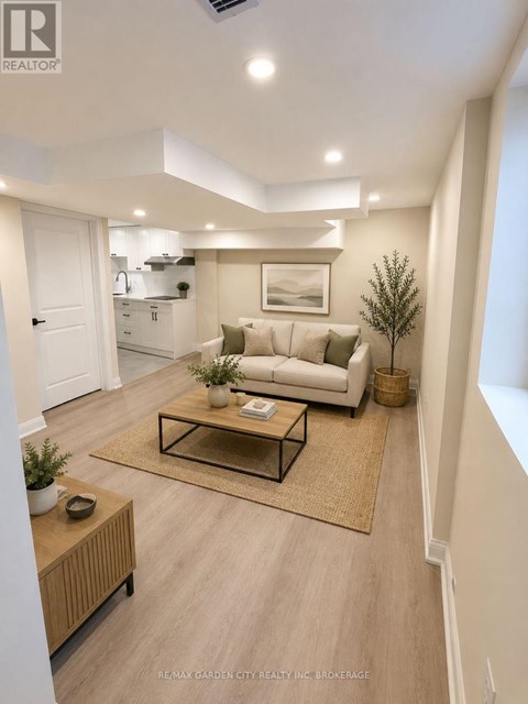 A well-lit, modern living room with a white sofa, a coffee table, and a rug.