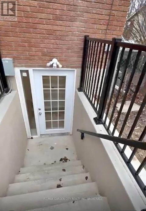 A white door with a glass window is on a staircase.