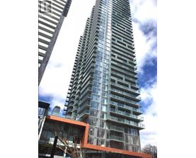A tall building with many windows and balconies is under construction.