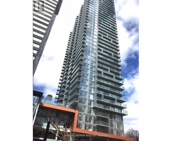 A tall building with many windows and balconies is under construction.