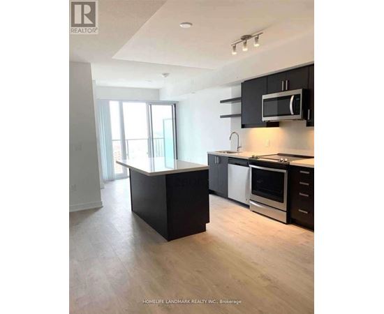 A kitchen with black cabinets and a white countertop.
