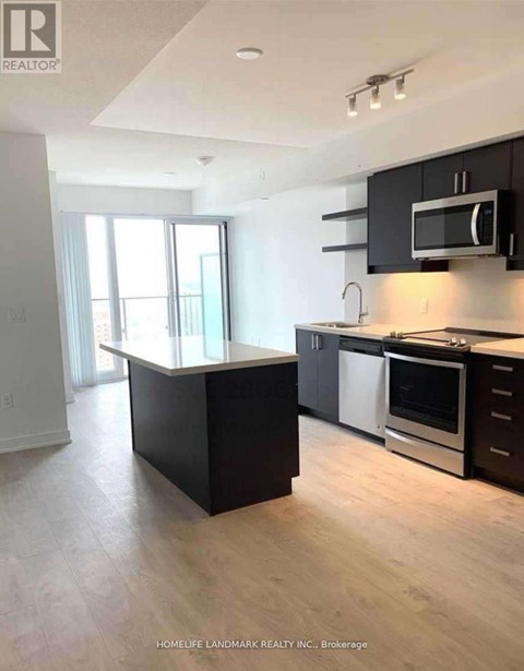 A kitchen with black cabinets and a white countertop.