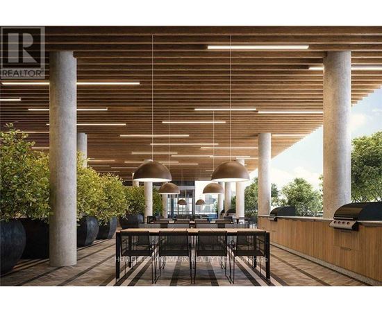 A modern outdoor dining area with a wooden ceiling and black chairs.