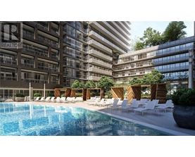 A pool area with chairs and a building in the background.