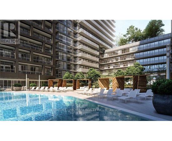 A pool area with chairs and a building in the background.