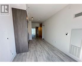 A spacious room with a sliding door leading to a balcony.