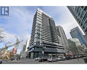 A tall building with a glass facade is the focal point of the image.