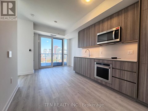 A modern kitchen with a microwave above the oven.
