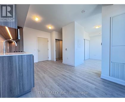 A realtor's office with a reception desk and a sign that says "TEN REALTY INC., Brokerage".