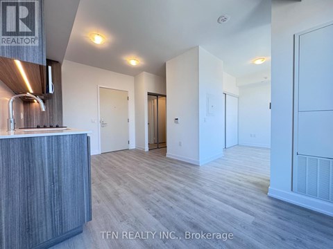 A realtor's office with a reception desk and a sign that says "TEN REALTY INC., Brokerage".