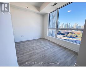 A room with a large window overlooking a cityscape.