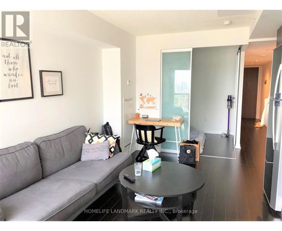 A living room with a grey couch and a coffee table.