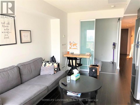 A living room with a grey couch and a coffee table.