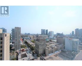 A cityscape with buildings of various heights and a clear sky.