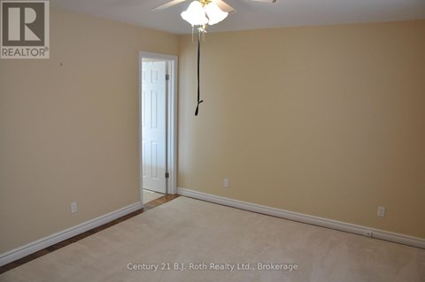 A room with a door and a light hanging from the ceiling.