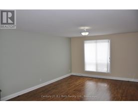 A room with a window and wooden floors.