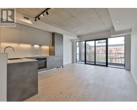 A spacious kitchen with a large island and a view of the city.