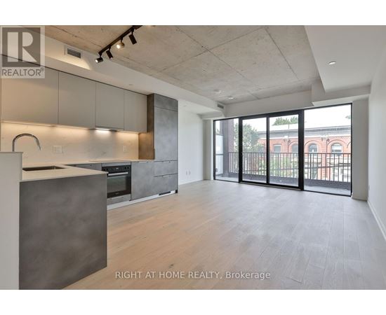 A spacious kitchen with a large island and a view of the city.