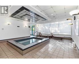 A pool in a room with tiled floors and ceilings.