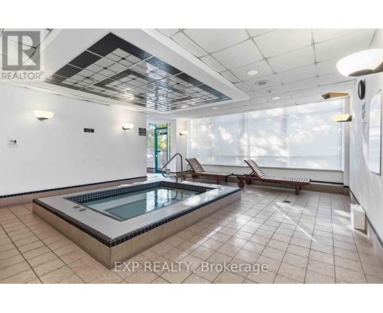 A pool in a room with tiled floors and ceilings.