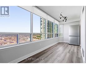 A room with a large window overlooking a cityscape.