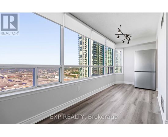 A room with a large window overlooking a cityscape.