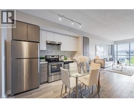 A modern kitchen with a dining area and a view of the city.