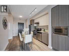 A modern kitchen with a dining table and chairs.