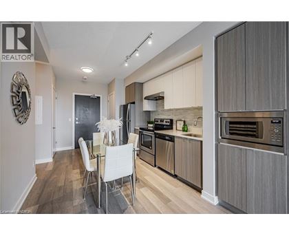 A modern kitchen with a dining table and chairs.