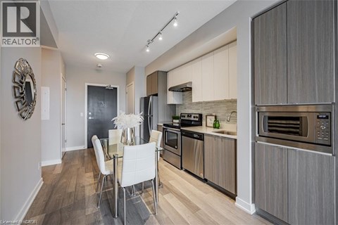 A modern kitchen with a dining table and chairs.