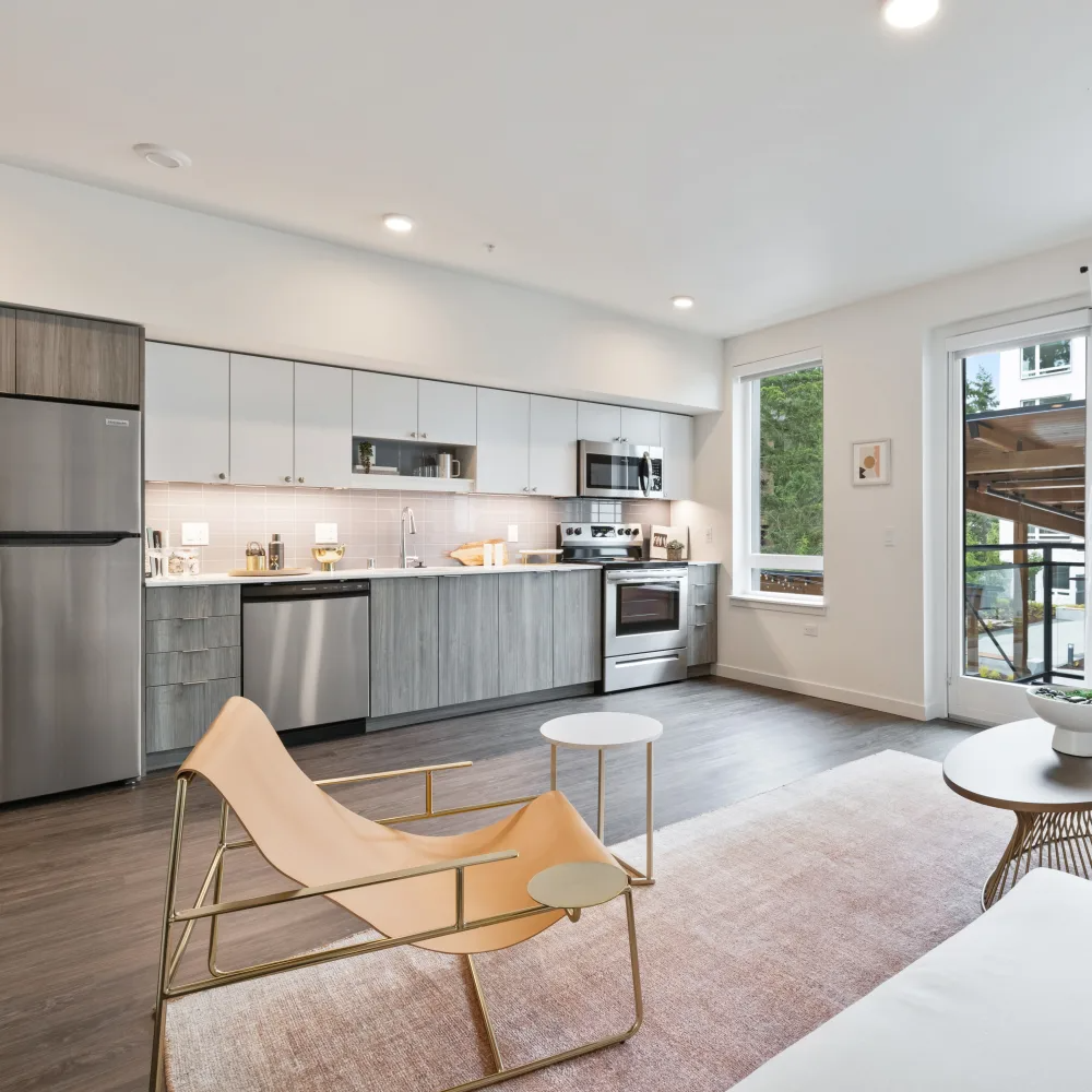 A modern kitchen with a dining table and chairs.