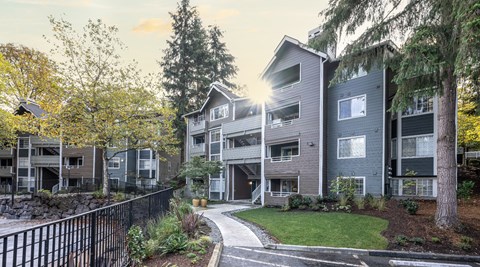 A modern apartment complex with a walkway in front.