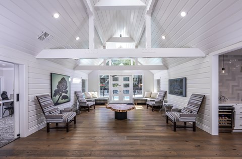 A living room with wooden floors and white walls.