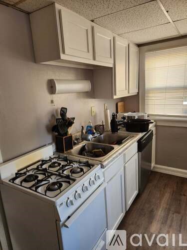 A kitchen with a white stove and a sink.