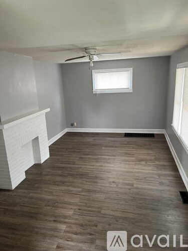 A room with a fireplace and a window.