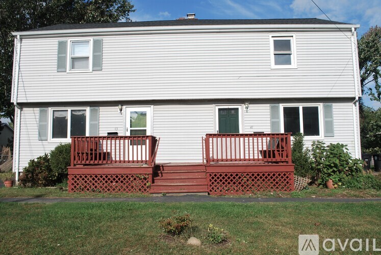 A house with a red front porch and a white siding exterior.