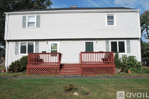 A house with a red front porch and a white siding exterior.