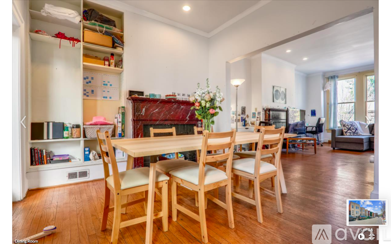 A dining room with a wooden table and chairs.