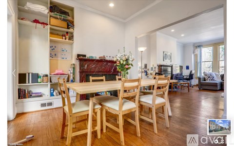 A dining room with a wooden table and chairs.