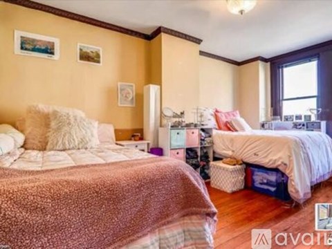 A bedroom with two beds and a dresser.