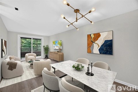 A modern dining room with a large table and chairs.
