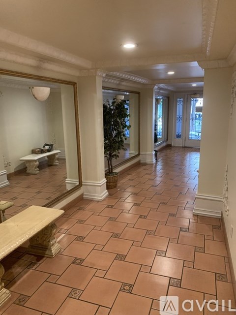 A hallway with a bench and a Christmas tree.