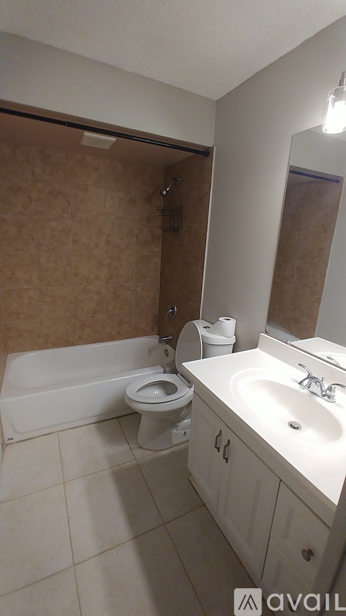 A bathroom with a toilet, sink, and mirror.