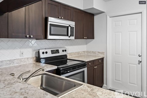 A kitchen with brown cabinets and a white door.