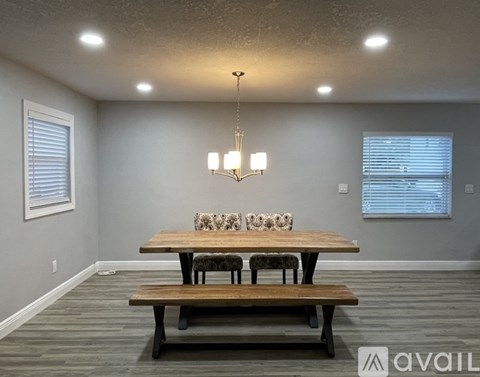 A dining room with a wooden table and benches.
