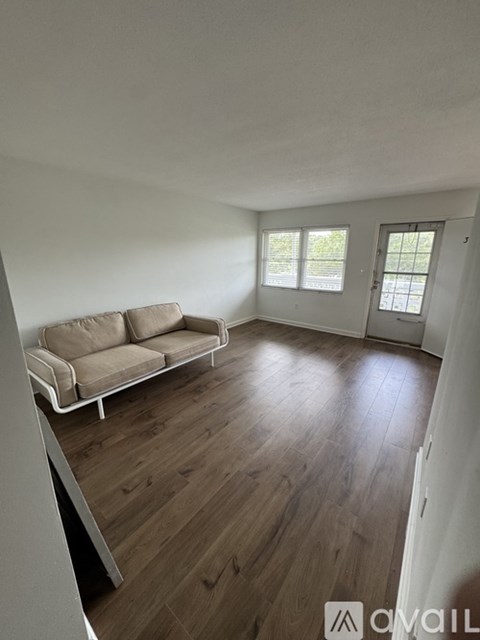 A living room with a couch and a door.